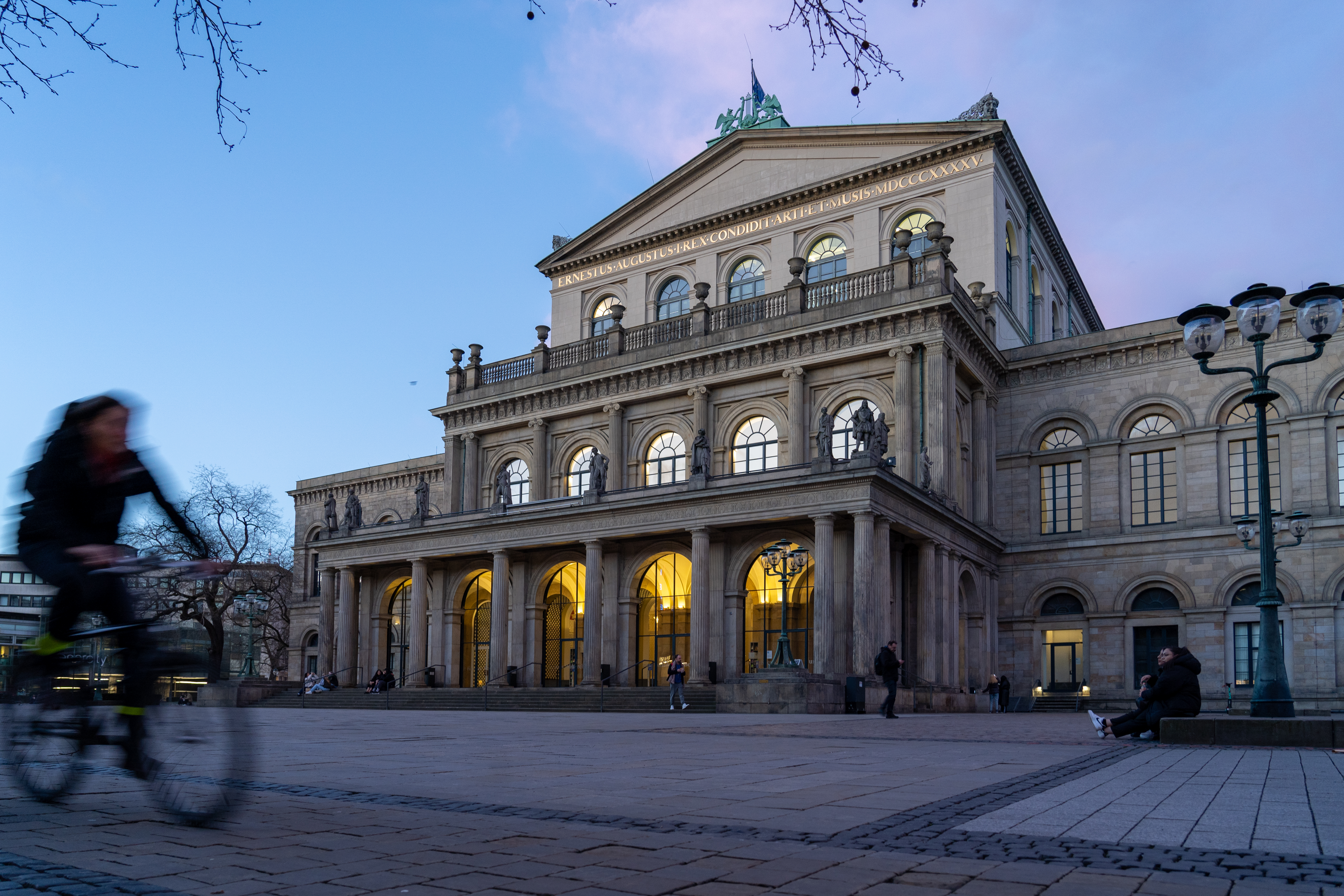Cyclist beside a historic building